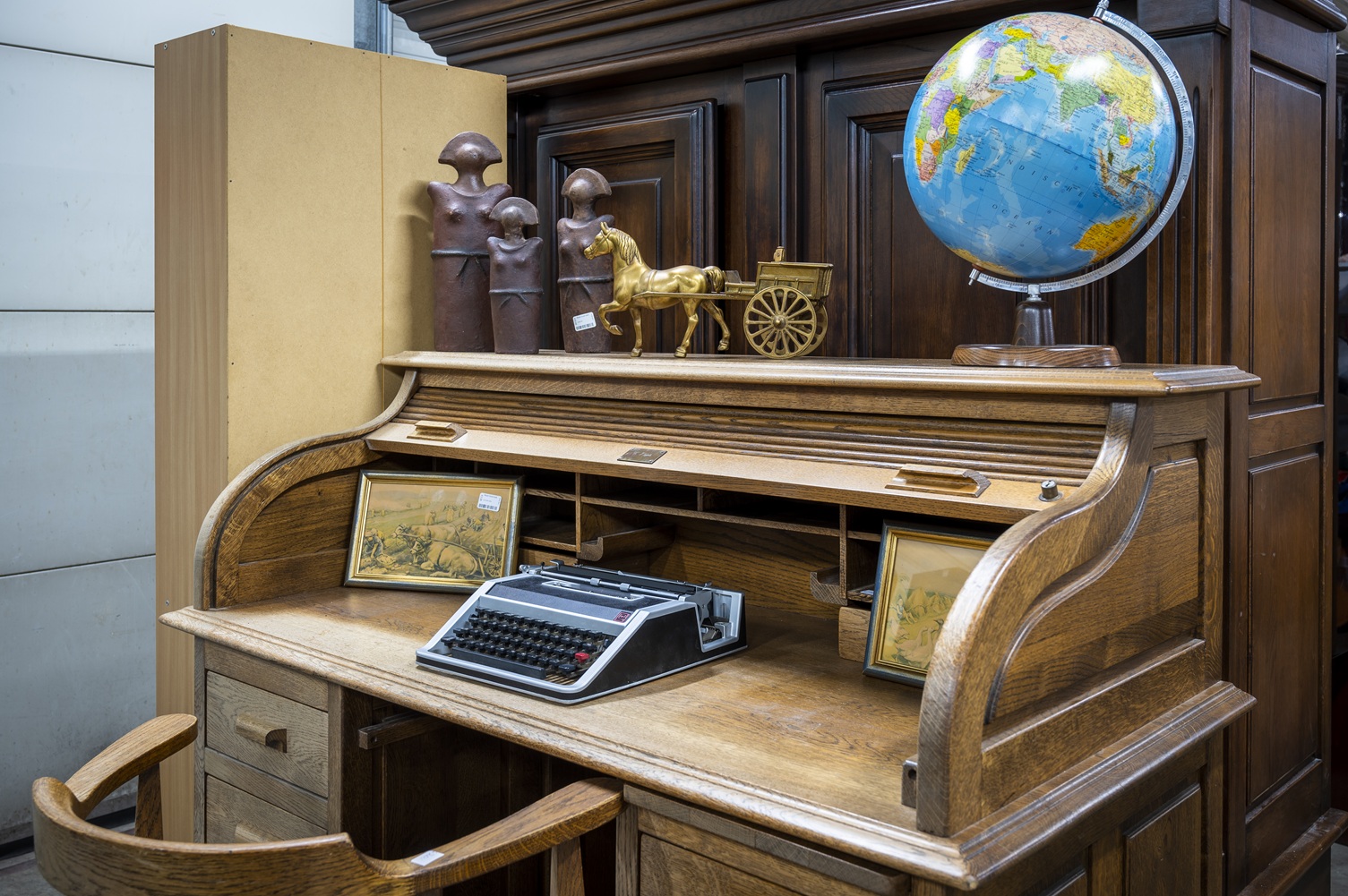 Vintage bureau met globe, typemachine en lijstjes tussen de 2dehands spullen in kringloopwinkel 't Tweede Kansje in Hilvarenbeek